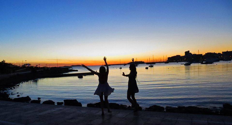 Two girls dancing at sunset in Ibiza