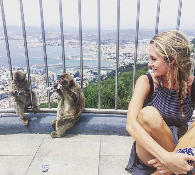 Author at Rock of Gibraltor, Spain, sitting and looking at two monkeys