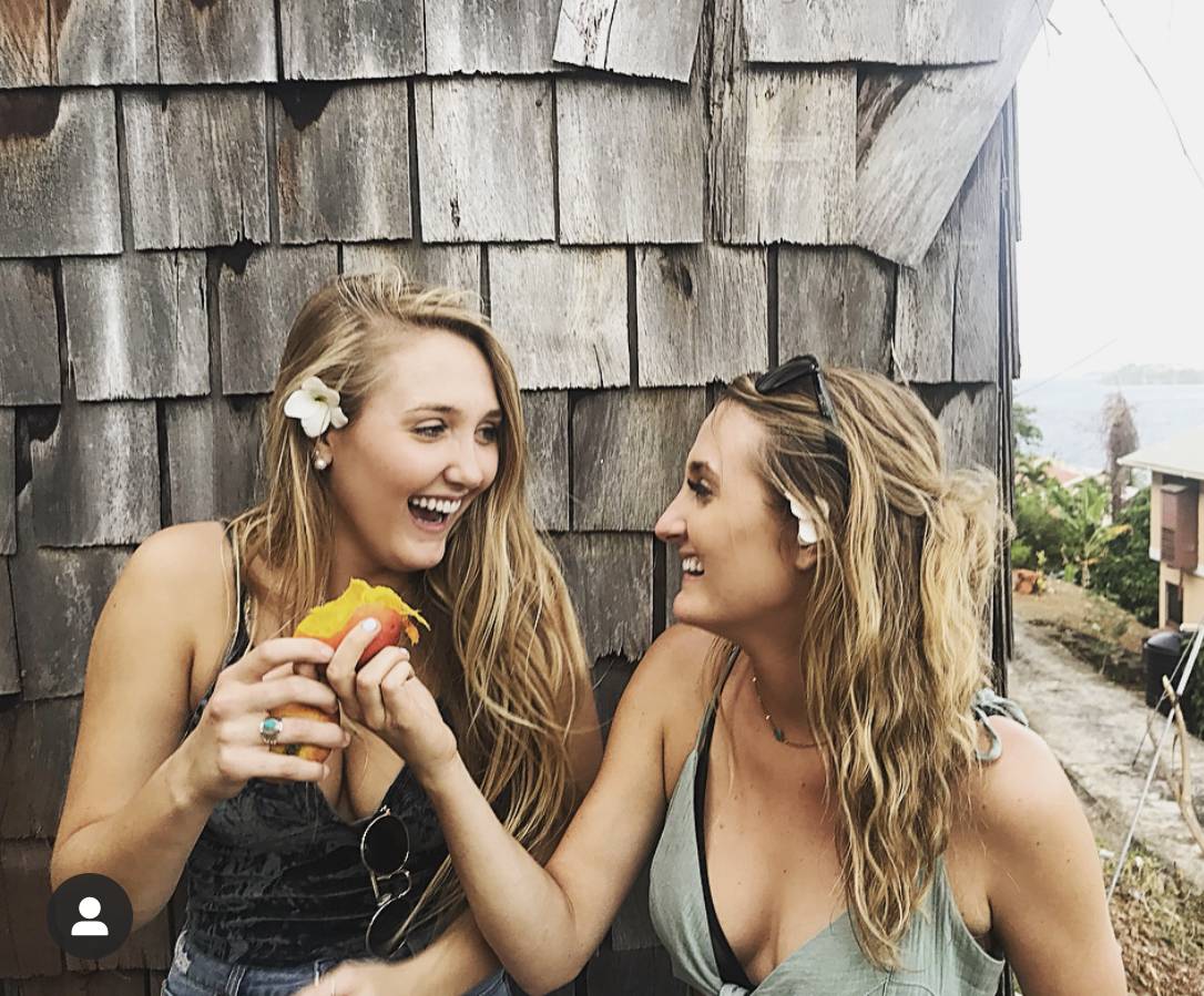 Two girls sharing a mango